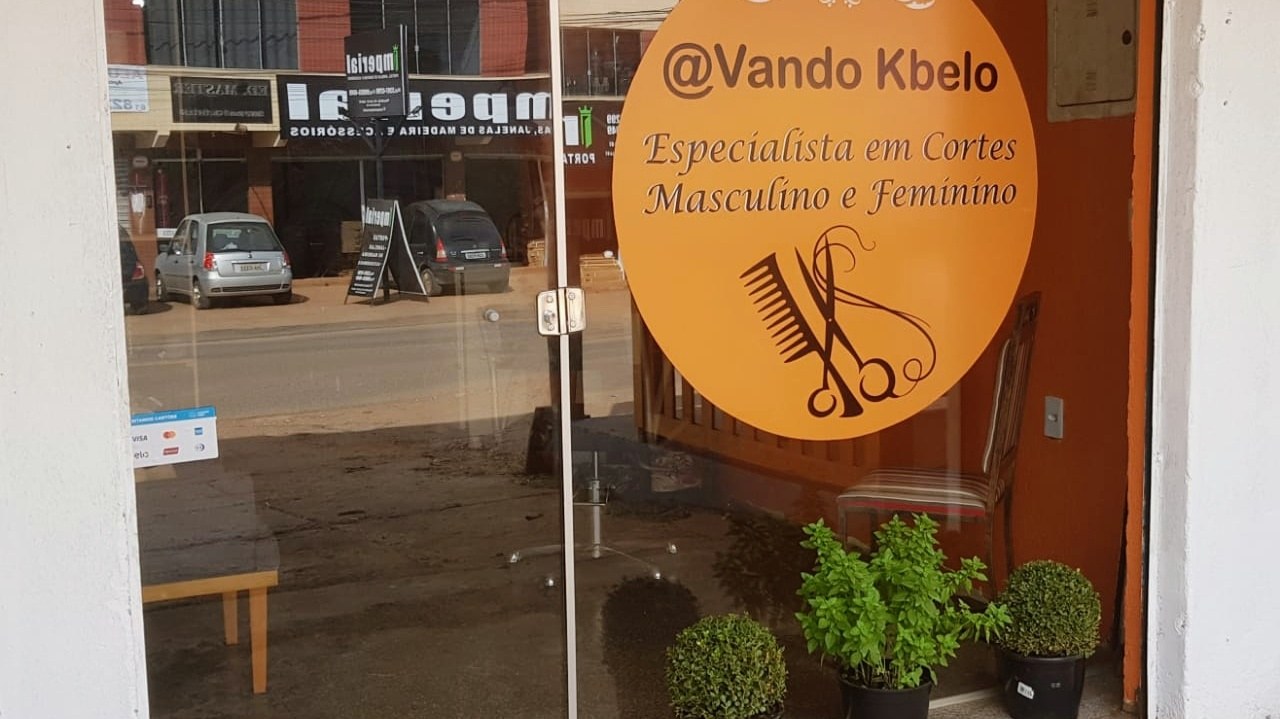 Porta de vidro do salão com o logo Vando Kbelo